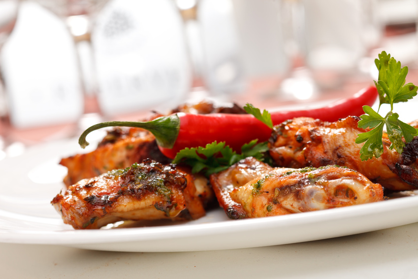 Grilled chicken drumsticks with a chili pepper on top